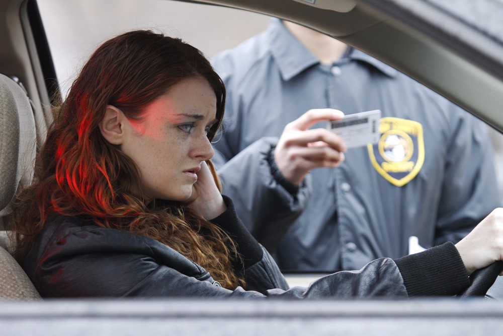 Young woman pulled over by police to receive a traffic ticket.